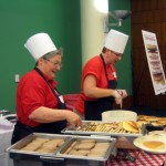 Dean Rooks and Assoc Dean Bruxvoort serve pancakes