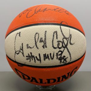 Close-up of range and white basketball with the autograph of Cynthia Cooper #14 MVP.